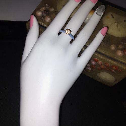 light blue ring with peach diamond